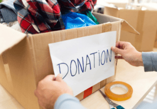 A person holding up a sign that says donation.